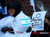 Karşı protestocular, Berlin, Almanya'da Filistin yanlısı bir gösteri sırasında İsrail yanlısı pankartlar taşıyor, 2 Aralık 2023 [Lisi Niesner/Reuters]